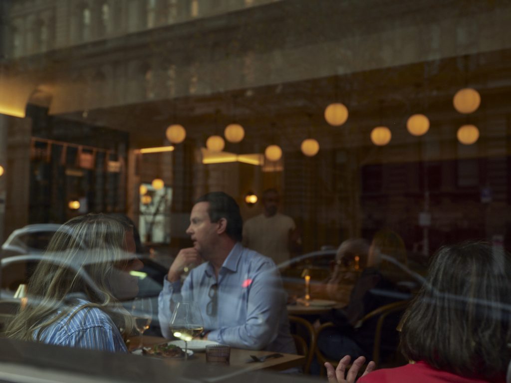 Guests dining at Bistrot Bisou, a stylish French restaurant on Flinders Lane in Melbourne.